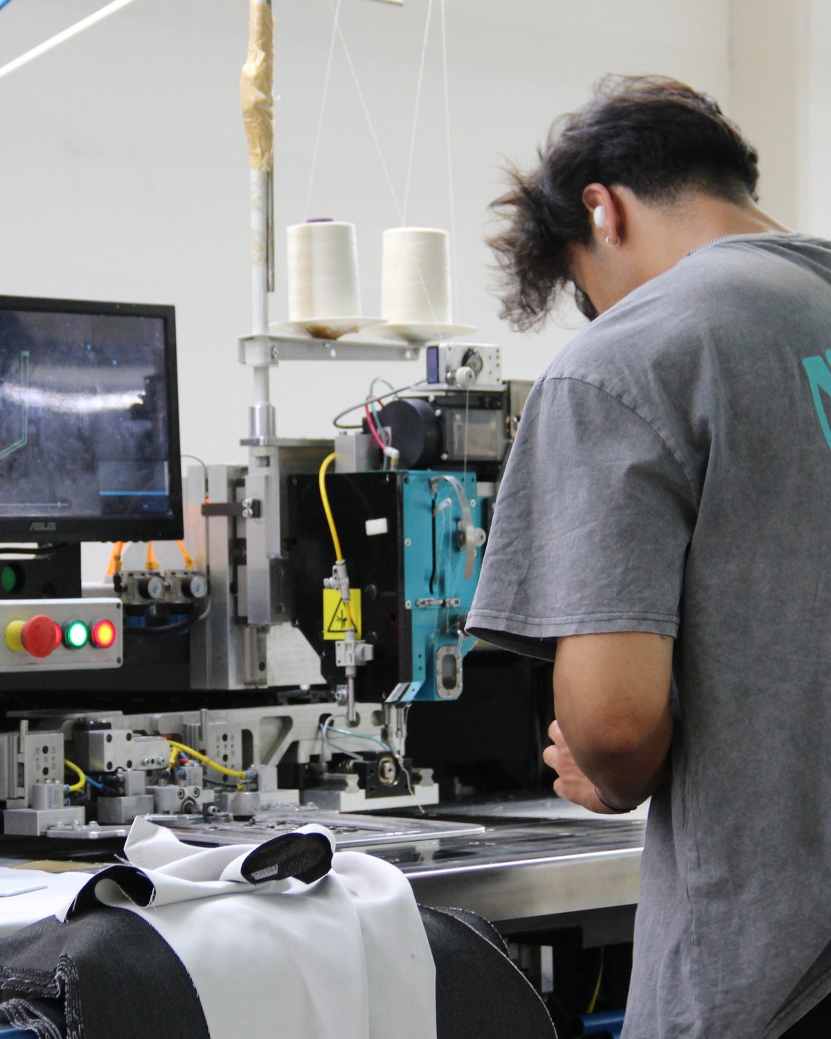 Precision detail production at the CRISTAL7 factory — computerized stitching for custom and private label work
